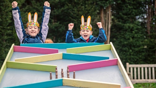 Children celebrating a win on the egg run during the Easter Adventures Trail at Dyffryn Gardens, Vale of Glamorgan